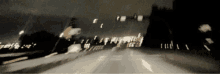 a blurry photo of a road at night