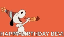 snoopy is wearing a party hat and blowing a party horn and saying `` happy birthday bev '' .