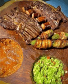 a wooden cutting board with a variety of food on it including guacamole