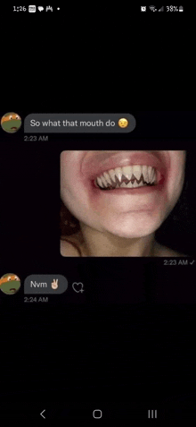 a close up of a person 's mouth with a smiley face on it and a picture of their teeth .