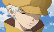 a man wearing a yellow hat says obrigado in a foreign language