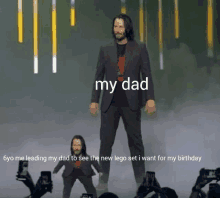 a man in a suit is standing in front of a crowd with a caption that says " my dad "