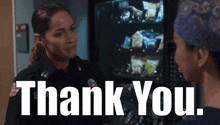 a woman in a police uniform talks to another woman in front of a vending machine with the words thank you