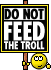 a sign that says do not feed the troll with a smiley face .