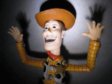 a toy story woody figure is smiling with his arms in the air