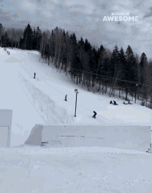 a snowboarder is doing a trick on a snowy slope with the words " people are awesome " in the background