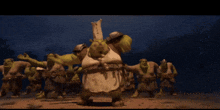 a group of shrek characters are dancing together in a dark room