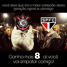 a man holding a microphone in front of a crowd with a corinthians logo and spfc logo