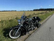 a black motorcycle is parked on the side of the road