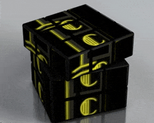 a black rubik 's cube with glowing yellow letters that spell out the word euro