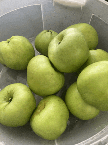 green apples in a clear plastic container