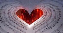 a heart is cut out of a book of music notes .