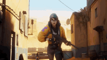 a woman in a yellow jacket is holding a gun in a narrow alleyway