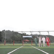 a group of people are standing on a soccer field with a sign that says ' korean ' on it