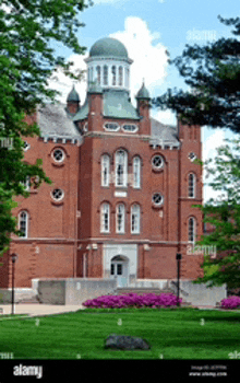 a large red brick building with a dome on top of it