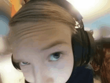 a person wearing headphones looks at the camera