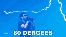 a man singing into a microphone with 80 dergees written in white on a blue background