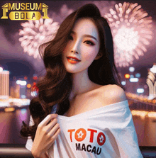 a woman wearing a toto macau shirt is standing in front of fireworks