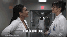 two female doctors talking in a hallway with the words stay in your lane written on the bottom