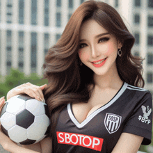 a woman holding a soccer ball in a sbotop shirt