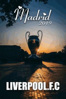 a poster for madrid 2019 with a large trophy in the foreground