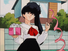 a girl is holding a pink gift box and a pink ribbon