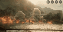 a boat in the water with smoke coming out of the mountains in the background