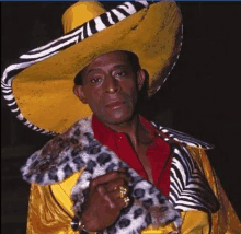 a man wearing a zebra print hat and a yellow coat