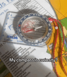 a compass on top of a map with the words " my compass is curiosity "