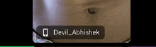 a close up of a person 's belly with the name devil abhishek written on it