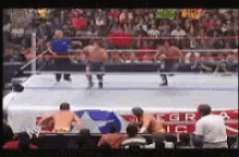 a wrestling match is being shown on a television screen