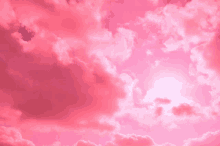 the sun is shining through the clouds in a pink sky