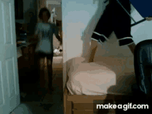 a gif of a person jumping on a bed with the words make a gif.com below them