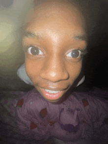 a close up of a person 's face with a strawberry blanket