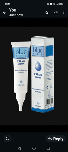 a tube of blue cap cream is next to its box