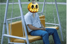 a man is sitting on a swing with a skull on his head and the words photoroom below him