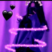 a girl is taking a selfie with a purple background and hearts .