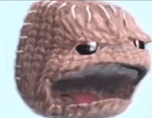 a close up of a stuffed animal 's face with its mouth open