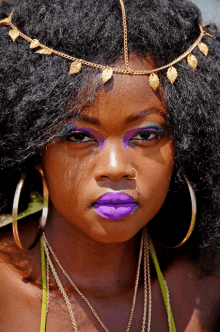 a close up of a woman 's face with purple lipstick