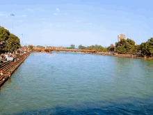 a bridge over a large body of water with a building in the background