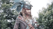 a man in a pirate costume with a feathered hat