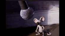 a cartoon mouse is standing next to a microphone with a red ball in its mouth .