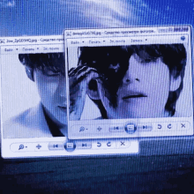 a computer screen shows a man taking a picture of another man with a camera