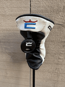 a black and white golf head cover with a crown and the letter b on it