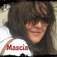 a woman wearing sunglasses has the name mascia written on her back