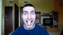 a man making a funny face in front of a television