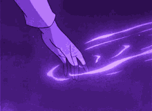 a person 's hand is touching a purple object with a purple background .