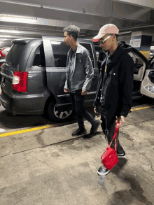 two men walking in a parking garage with a sign that says level 1