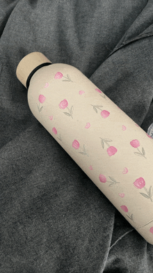 a water bottle with pink flowers and hearts on it