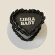 a heart shaped cake with the words `` libra baby '' on it .